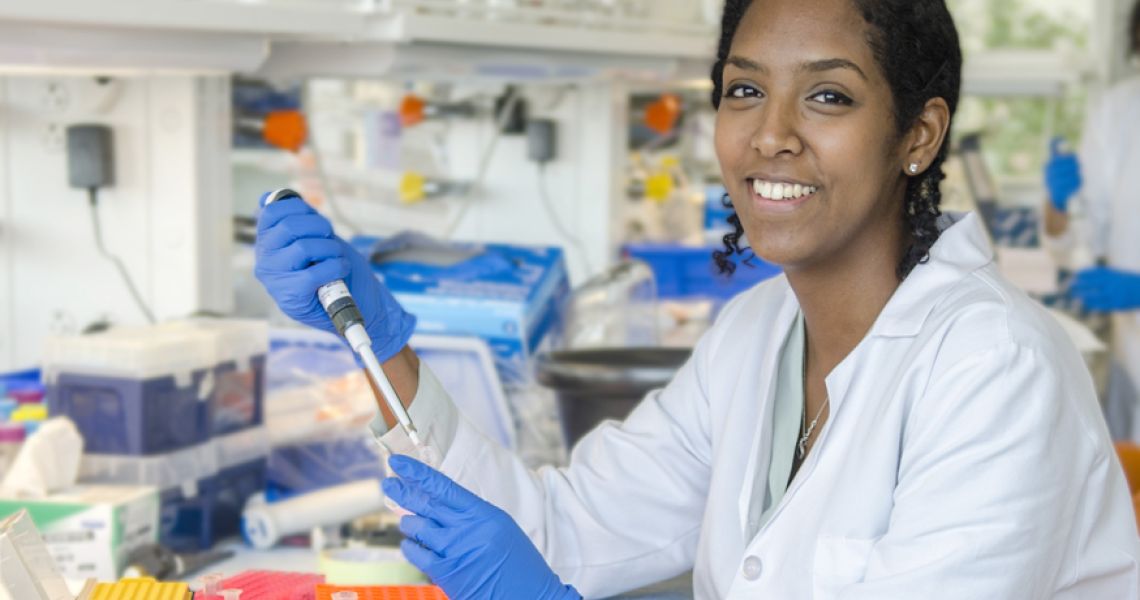 Eden Dejean at the laboratory bench.