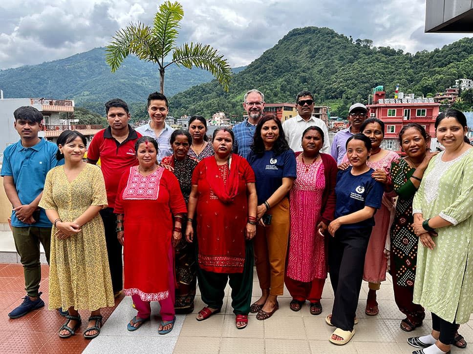 Brandon Kohrt standing with Nepalese community health workers