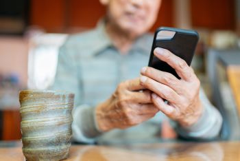 Elderly man taking a cell phone call