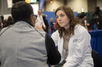 Event attendee talks with doctor 