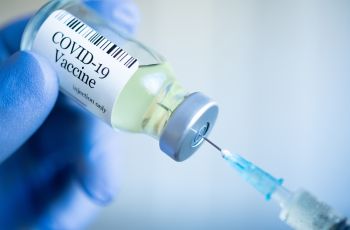 Needle in a vial of COVID-19 Vaccine